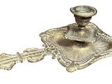 a silver candle holder with a clock on it