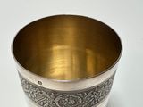 a silver cup that is sitting on a table