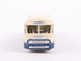 a toy bus that is sitting on a white surface