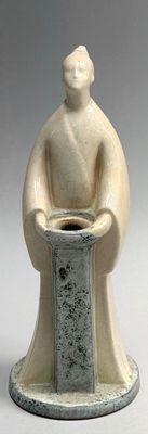 a statue of a man sitting on a pedestal holding a pot