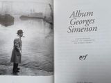 an open book with a picture of a man standing by the water