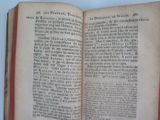 a book open on a table with a white background