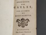 an old book with a picture of a coat of arms on it