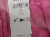 the label on a pink jacket is attached to a pink jacket
