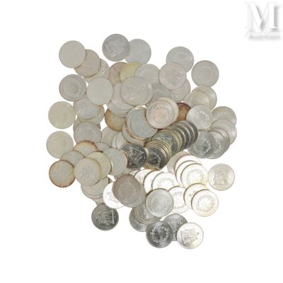 a pile of coins sitting on top of a white surface