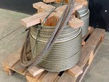 a pile of rope on a pallet next to a black wall
