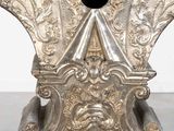 a silver statue of a man with a hat on