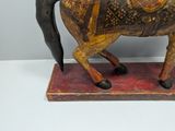 a statue of a horse with a saddle on it ' s back