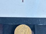 a gold coin on display in a glass case