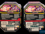 two packs of pokemon trading cards in plastic packaging on a black background