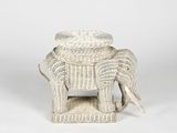 an elephant shaped stool with a seat made out of wicker