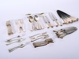 a lot of silverware on a white table