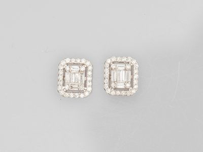 a pair of diamond and white gold earrings