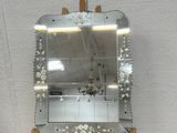 a mirror that is on a small wooden stand