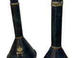 two black candlesticks that are sitting next to each other