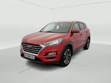 a red 2019 hyundai tucson parked in a white room