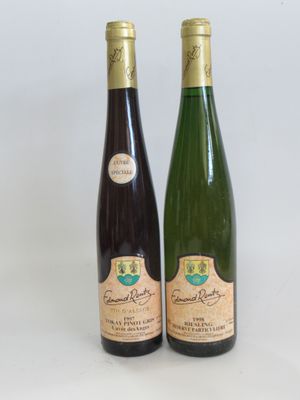 two bottles of wine sitting next to each other on a table