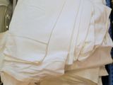 une pile de draps blancs pliés dans un bac bleu