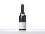 bottle of red wine sitting on top of a white table