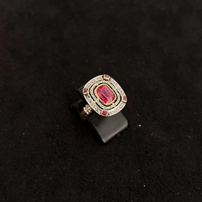 a close up of a red and white ring on a black surface