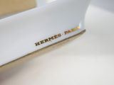a white plate with a gold rim and a name on it