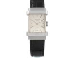 une photo d'une montre carrée blanche avec un bracelet en cuir noir