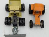 two toy trucks sitting next to each other on a white surface