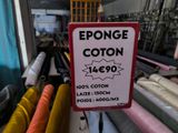 a sign that says sponge cotton on it in front of many fabrics