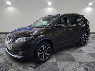 the black nissan suv is parked on a checkered floor