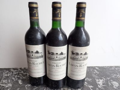 three bottles of wine sitting on top of a table next to each other
