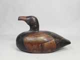 an image of a wooden duck sitting on top of a white surface