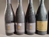 six bottles of wine are lined up in a row on a table