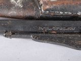 a close up of a gun on a white surface