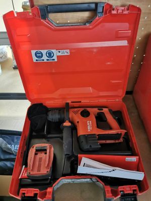 a red tool box with tools in it on a table