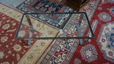 a glass table with a glass top on a rug