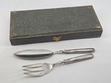 two forks and a spoon sitting next to a book