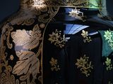 a large black vase with gold designs on it