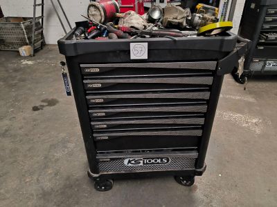 a black tool box with tools in it in a garage