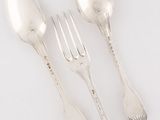 three silver spoons and a fork on a white surface