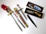 three different types of knives and a box on the table