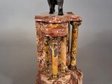 statue of an elephant on top of a column with columns
