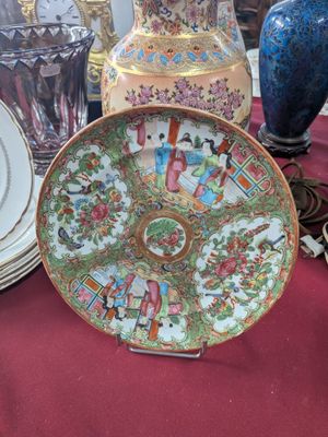 a lot of plates and vases sitting on a table