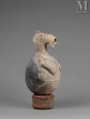 an image of a vase with a bird on top of it