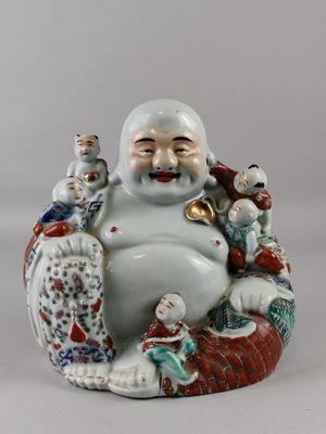 a figurine of a smiling man with a bunch of dolls