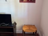 an image of a living room with a television and a chair
