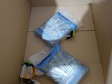 three bags of toilet paper in a box on the floor