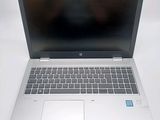 an open laptop computer sitting on top of a white table