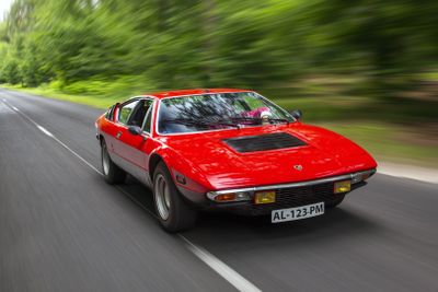 an image of a red sports car driving down the road