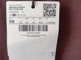 the label on the back of a brown jacket with a barcode on it