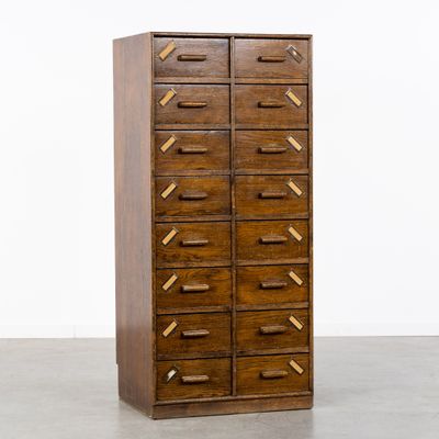 une image représentant une grande armoire en bois comportant de nombreux tiroirs